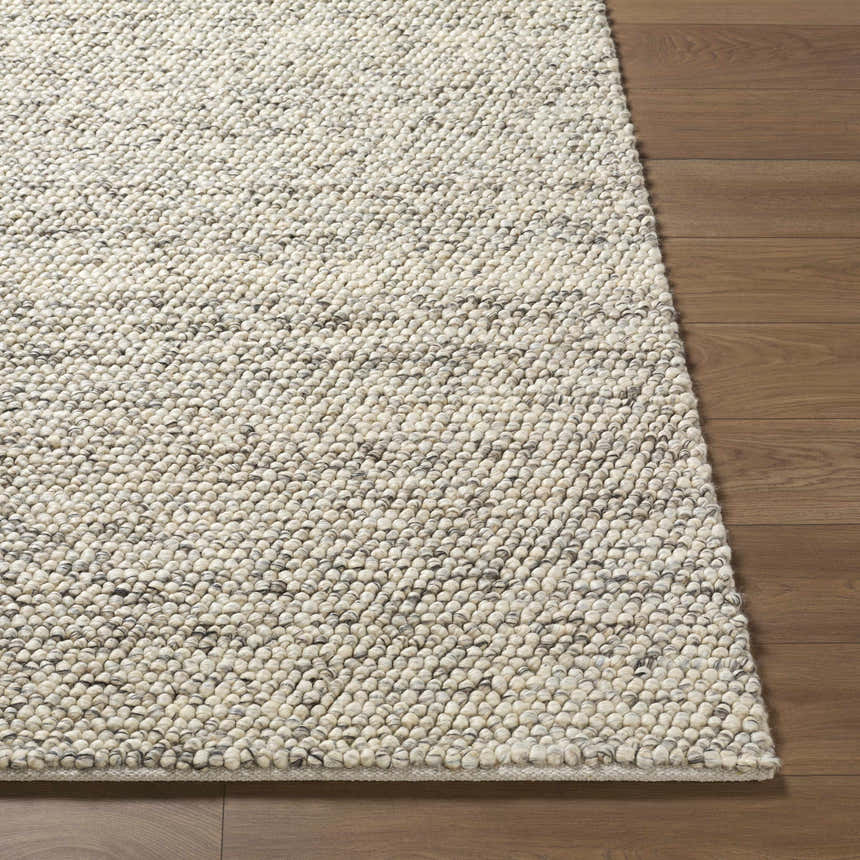 Close-up of the hand woven Clayne Beige & Charcoal Premium Wool Area Rug showing its textured, looped wool design. Front
