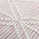 Close-up of the Ramsbury Soft Pink Wool Rug showing geometric pattern and textured, hand-woven detail. Texture