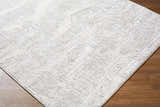 Close up of the Annisa Area Rug. Cream, ivory, and light gray geometric pattern. Contemporary style. Corner