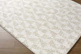 Close up of the Ceylan Area Rug, a shag rug in medium gray and white with a subtle geometric pattern. Corner