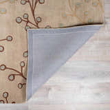 Close-up of the Elsu Beige&Gray Wool Rug, showing floral design, wool texture, and rug backing. Fold