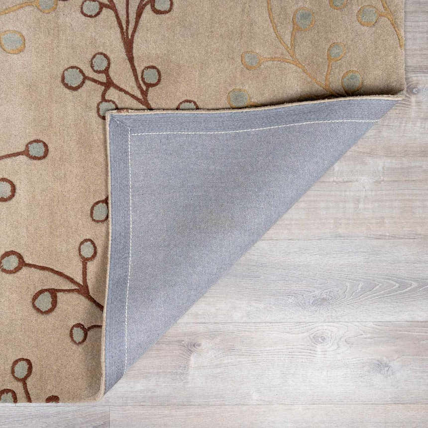 Close-up of the Elsu Beige&Gray Wool Rug, showing floral design, wool texture, and rug backing. Fold