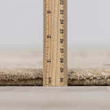 Close up of the pile height of the hand-tufted Elsu Beige&Gray Wool Rug. Pile
