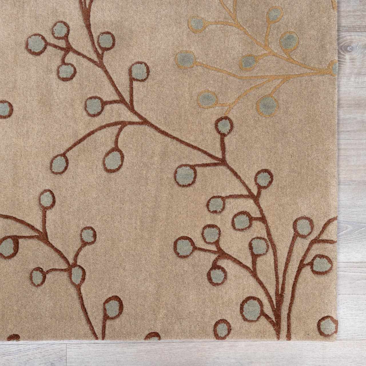 Close-up of the hand-tufted Elsu Beige&Gray Wool Rug. Features a brown and tan floral design on a beige background. Swatch