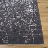 Close-up of the Corina Black Area Rug showing its charcoal, gray, and ivory traditional design and soft texture. Front