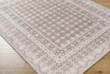 Close-up of the Rainier Light Brown Washable Rug. Cream, dark and light brown traditional pattern. Machine woven polyester rug. Corner
