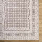 Close-up of Rainier Light Brown Washable Rug. Farmhouse style rug with cream, dark brown, and light brown traditional pattern. Swatch