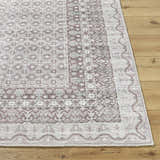 Close-up of the Rainier Brown Washable Rug showing its traditional brown, gray, and sage pattern and machine-woven texture. Front