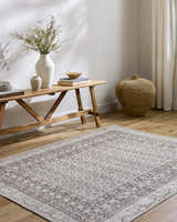 Entryway with Rainier Brown Washable Rug, wood bench, vases, books, and woven basket for a farmhouse feel. Roomscene-Rectangle
