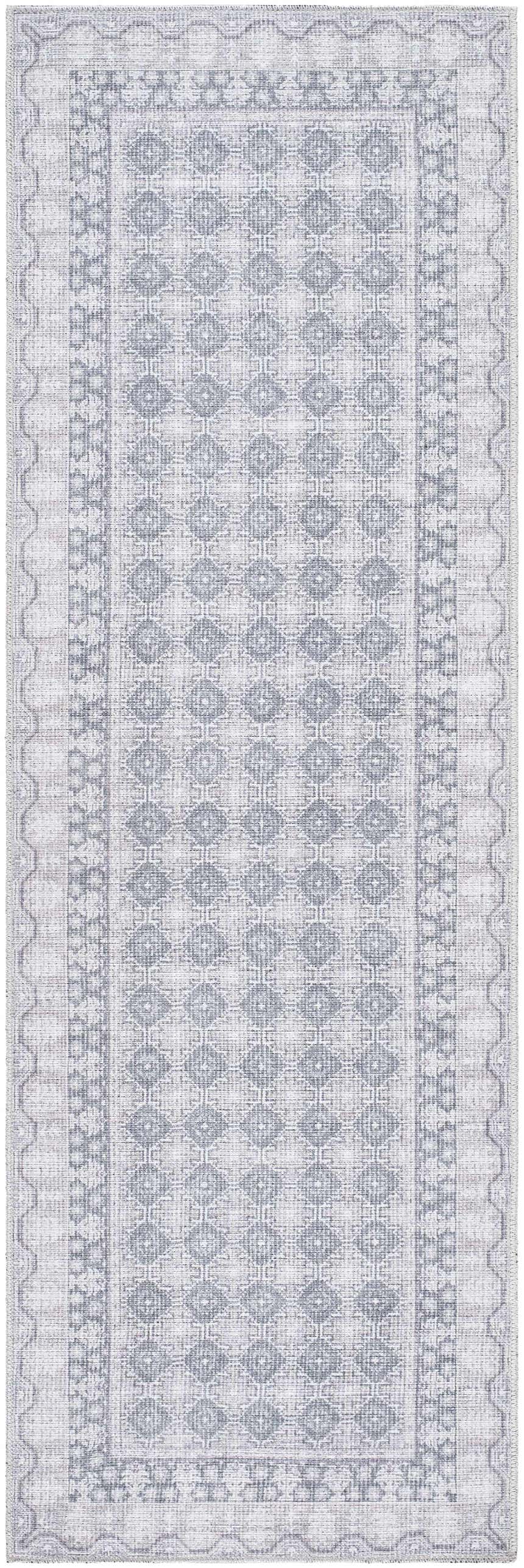 Close-up of the Rainier Blue Washable Rug. Features a pale blue geometric pattern and traditional border design. Design-Runner-27710