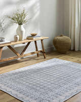 Entryway with Rainier Blue Washable Rug, wood bench with vases, and woven basket for a farmhouse feel. Roomscene-Rectangle
