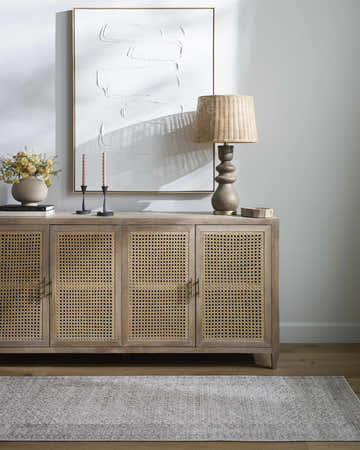Living room scene with a Spokane Cream Area Rug, wood floors, and a stylish console table. Roomscene-Rectangle