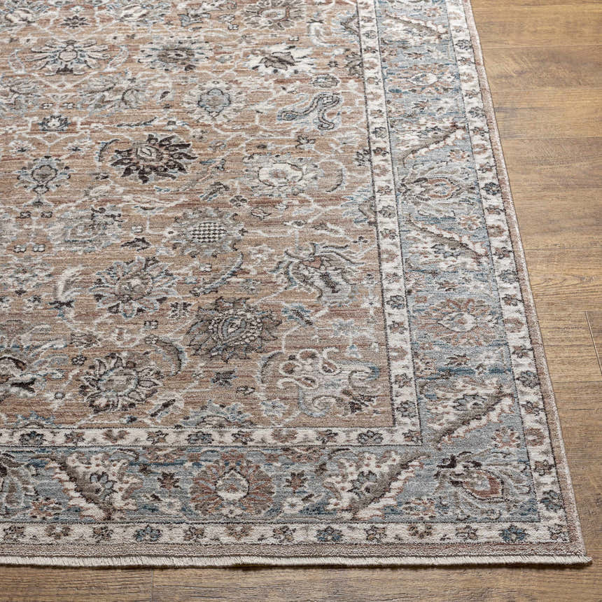 Close up of the Civankan Area Rug. Traditional floral pattern in brick red, denim, and brown on wood floor. Front