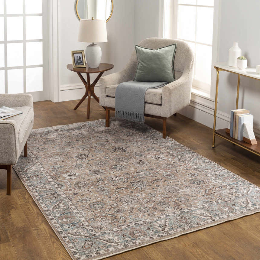 Living room scene with a traditional Civankan Area Rug in brick red, denim, and ivory. The rug complements the neutral furniture and wood floors. Roomscene-Rectangle