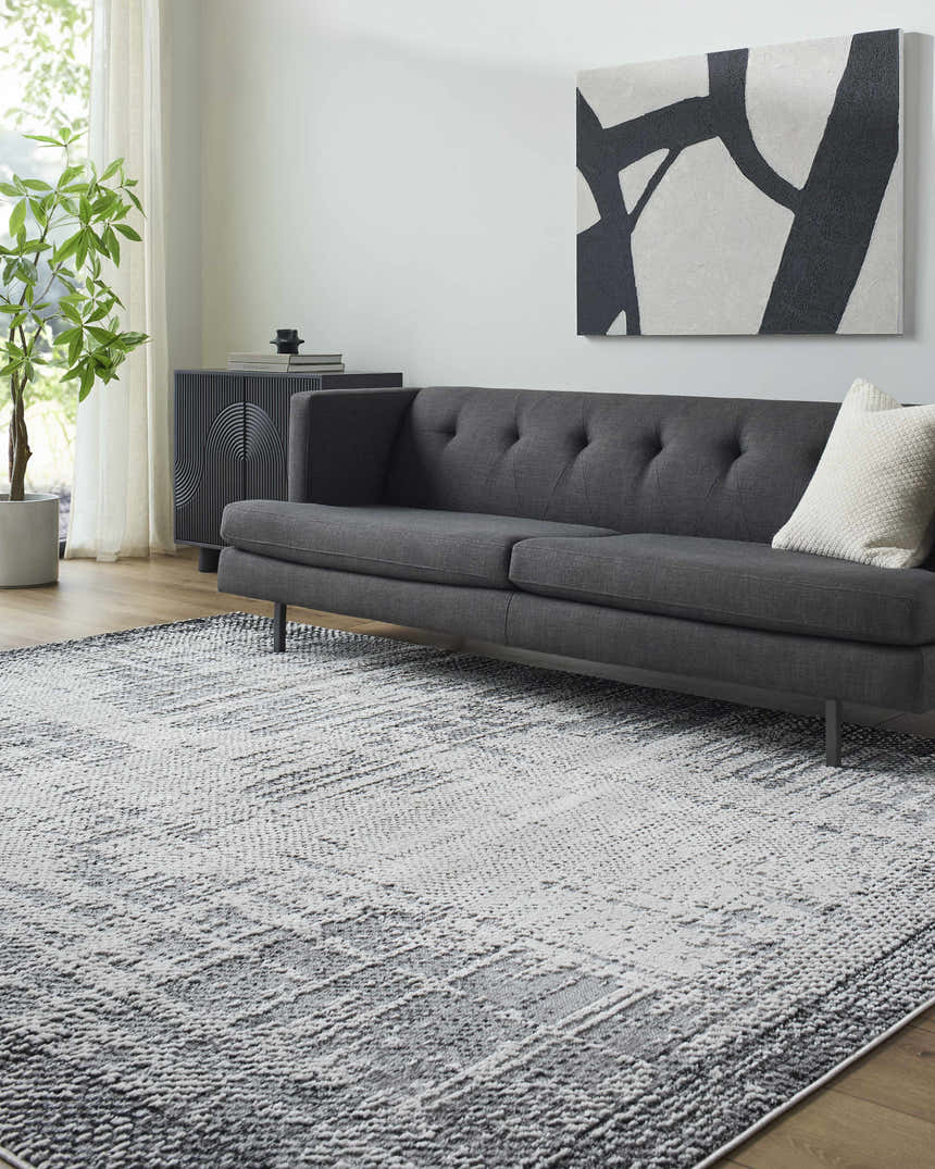 Living room scene with a gray sofa and the Colson Gray Area Rug in light silver and onyx. Roomscene-Rectangle