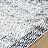 Close-up of the Colson Gray Area Rug showing its light silver, onyx, and silver gray contemporary pattern. Texture