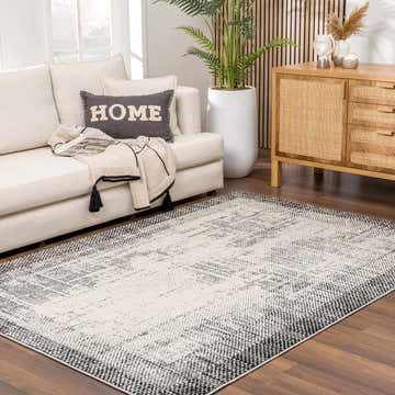 Living room scene with a Colson Gray Area Rug, cream sofa, wood cabinet, and houseplants. Roomscene-Rectangle