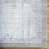 Close up of Colson Sage Area Rug, a contemporary rug with ash, silver gray, and slate blue tones. Corner