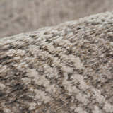 Close-up of the Colson Sage Area Rug showing its soft, textured pile in ash, pale pink, and silver gray. Fold