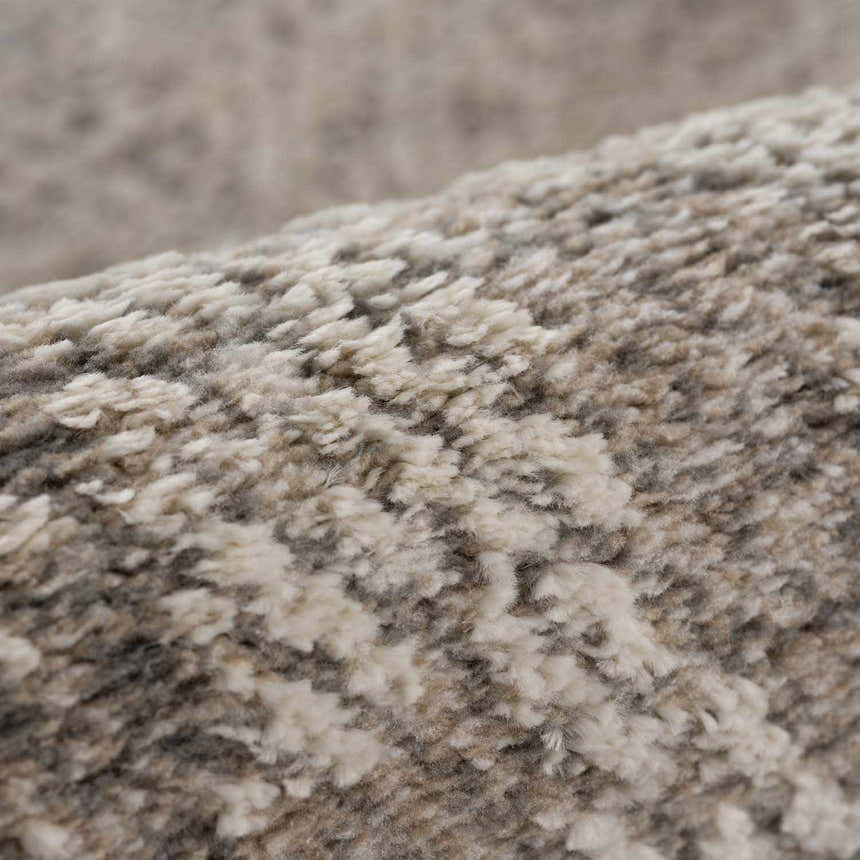 Close-up of the Colson Sage Area Rug showing its soft, textured pile in ash, pale pink, and silver gray. Fold