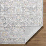 Close-up of the Xiye Silver Medallion Rug showing the traditional pattern, colors, texture, and machine-woven construction. Fold