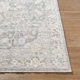 Close-up of the Xiye Silver Medallion Rug showing its traditional medallion pattern and soft texture on a wood floor. Front