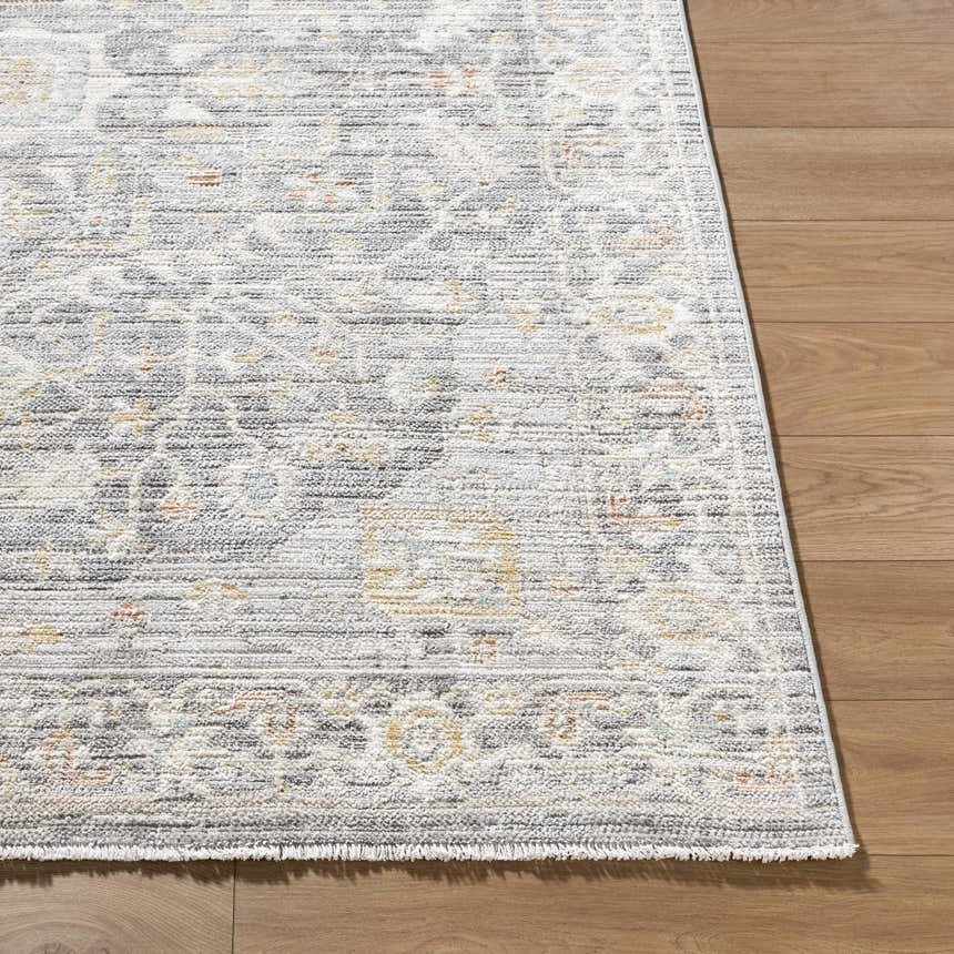 Close-up of the Xiye Silver Medallion Rug showing its traditional medallion pattern and soft texture on a wood floor. Front