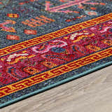 Close up of the Cleveland Colorful Traditional Area Rug showing teal, red, and yellow geometric patterns. Corner