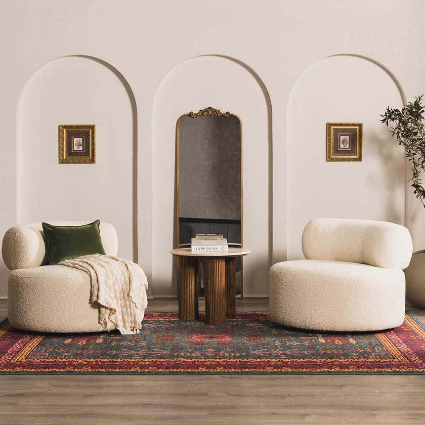 Living room scene with the Cleveland Colorful Traditional Area Rug in teal, aqua, and navy, paired with cream chairs and arched decor. Roomscene-Rectangle