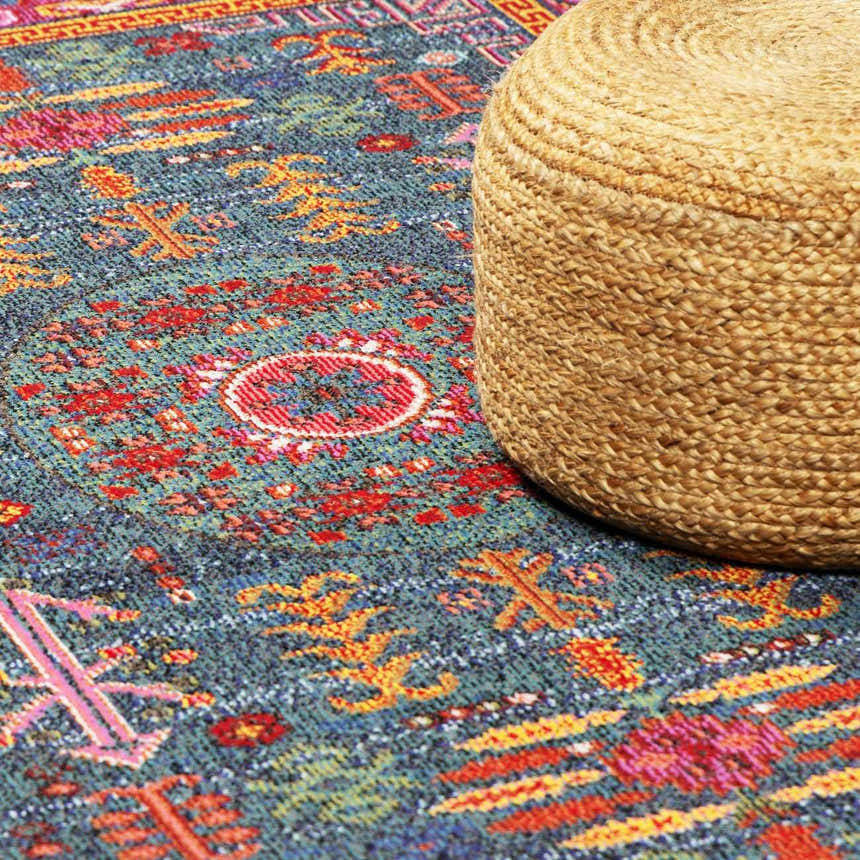 Close up of the teal Cleveland Colorful Traditional Area Rug with a jute pouf. Styleshot