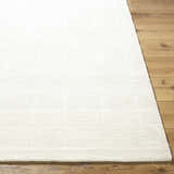 Close up of the Charan Ivory Cream Area Rug showing its textured, geometric pattern and 100% wool material. Front