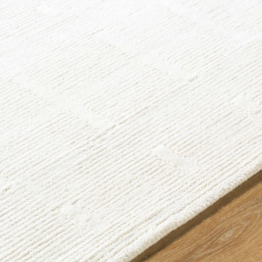 Close up of the hand tufted Charan Ivory Cream Area Rug showing texture and subtle geometric pattern. Texture