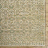 Close-up of Becki Owens x Livabliss Renaissance BORI-2304 rug. Beige, olive, tan, and taupe floral and geometric pattern. Corner