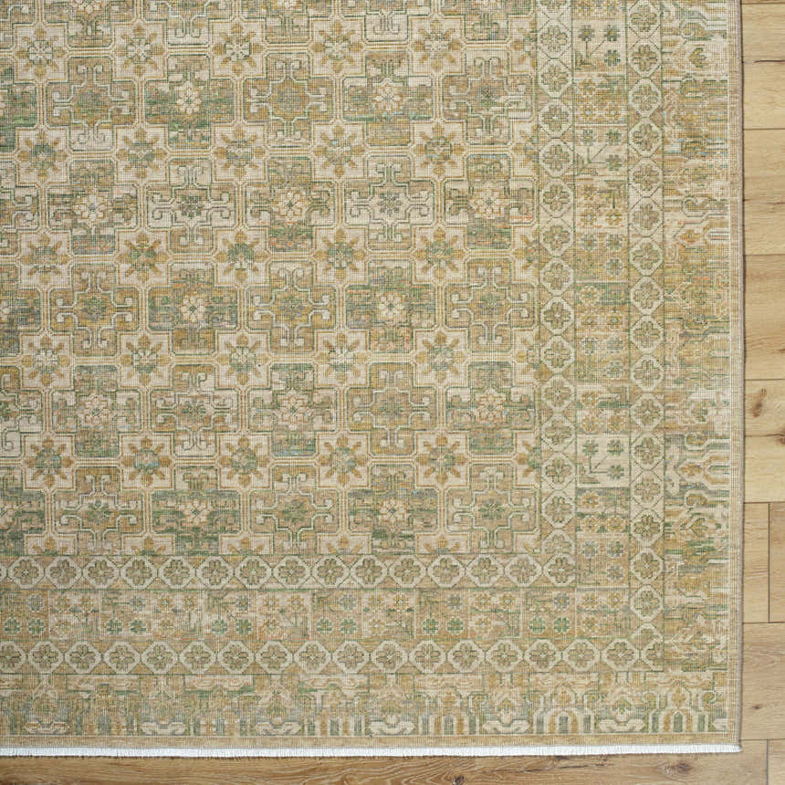 Close-up of Becki Owens x Livabliss Renaissance BORI-2304 rug. Beige, olive, tan, and taupe floral and geometric pattern. Corner