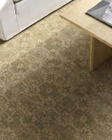 Close-up of Becki Owens x Livabliss Renaissance BORI-2304 rug. Beige, olive, tan, and taupe floral pattern. 100% wool texture. Styleshot