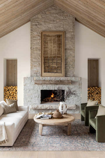 Living room scene with a Crevan Washable Area Rug in dark red, denim, light sage, and tan colors under a rustic wood coffee table. Roomscene-Rectangle