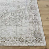 Close up of the Clodia Area Rug showing its traditional charcoal, ivory, and silver gray pattern and hand tufted texture. Front