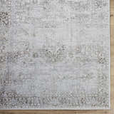 Close up of the hand tufted Clodia Area Rug, showcasing its charcoal, ivory, and taupe traditional pattern. Swatch