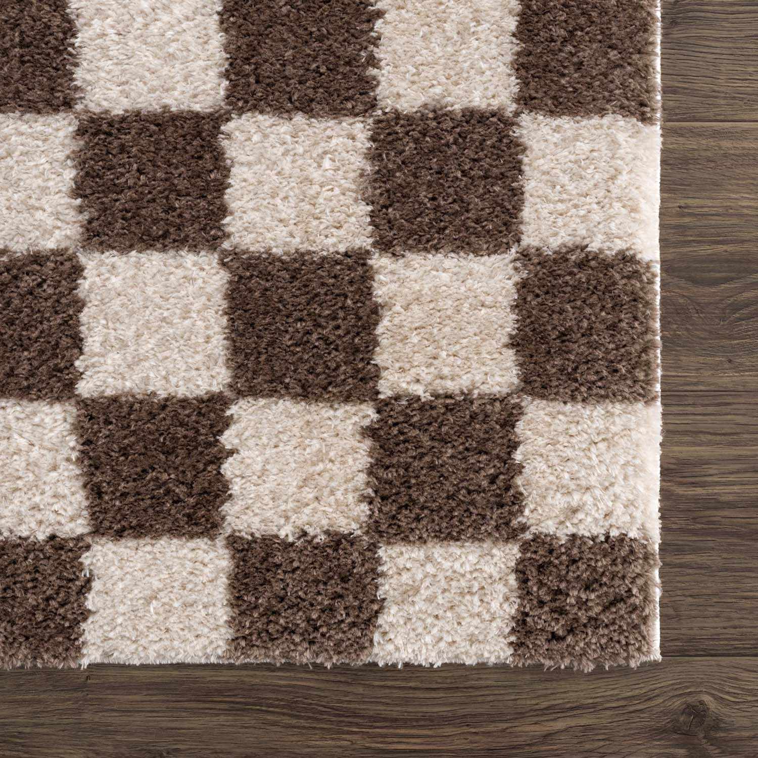 Close up of the Canika Brown Washable Checkered Area Rug showing its dark brown and beige checkerboard pattern. Swatch