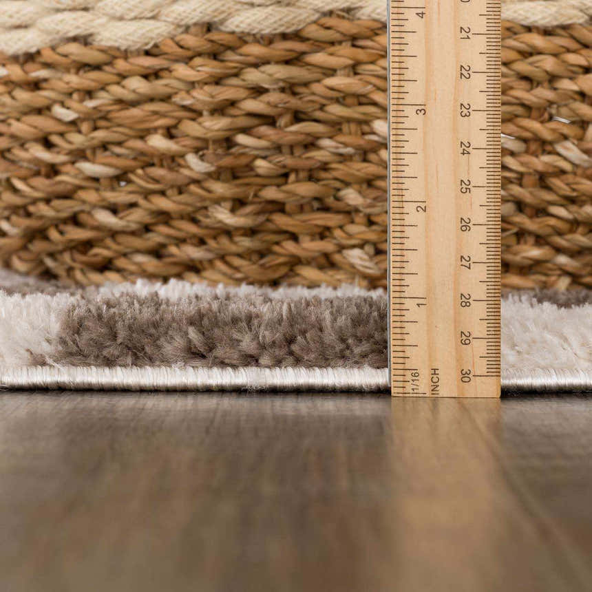 Close up of the Canika Brown Washable Checkered Area Rug showing pile height with a ruler and basket. Pile