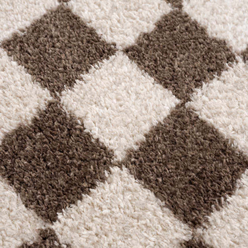 Close-up of the Canika Brown Washable Checkered Area Rug, showing its dark brown and peach diamond pattern and soft, textured weave. Texture