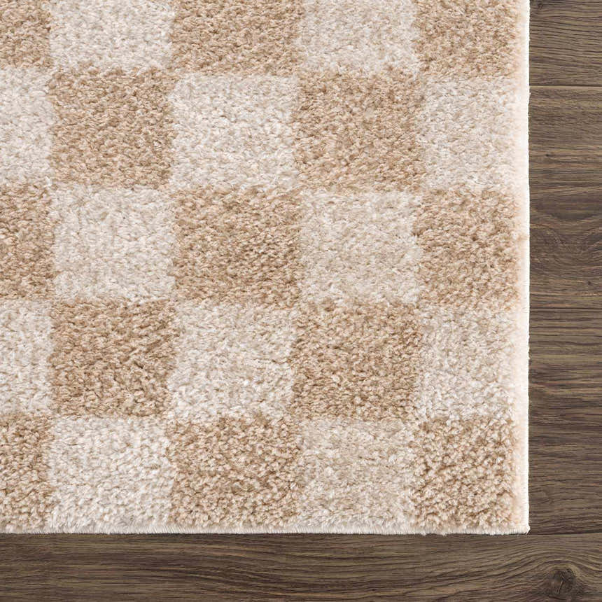 Close-up of Canika Checkered Cream Washable Area Rug. Beige and peach checkerboard pattern, soft polyester texture. Swatch