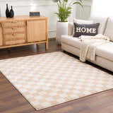 Living room scene with Canika Checkered Cream Washable Area Rug, beige sofa, wood cabinet, and potted plant. Roomscene-Rectangle