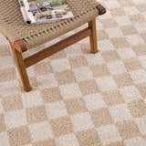 Close up of Canika Checkered Cream Washable Area Rug featuring a beige and cream checkered pattern and soft texture. Styleshot