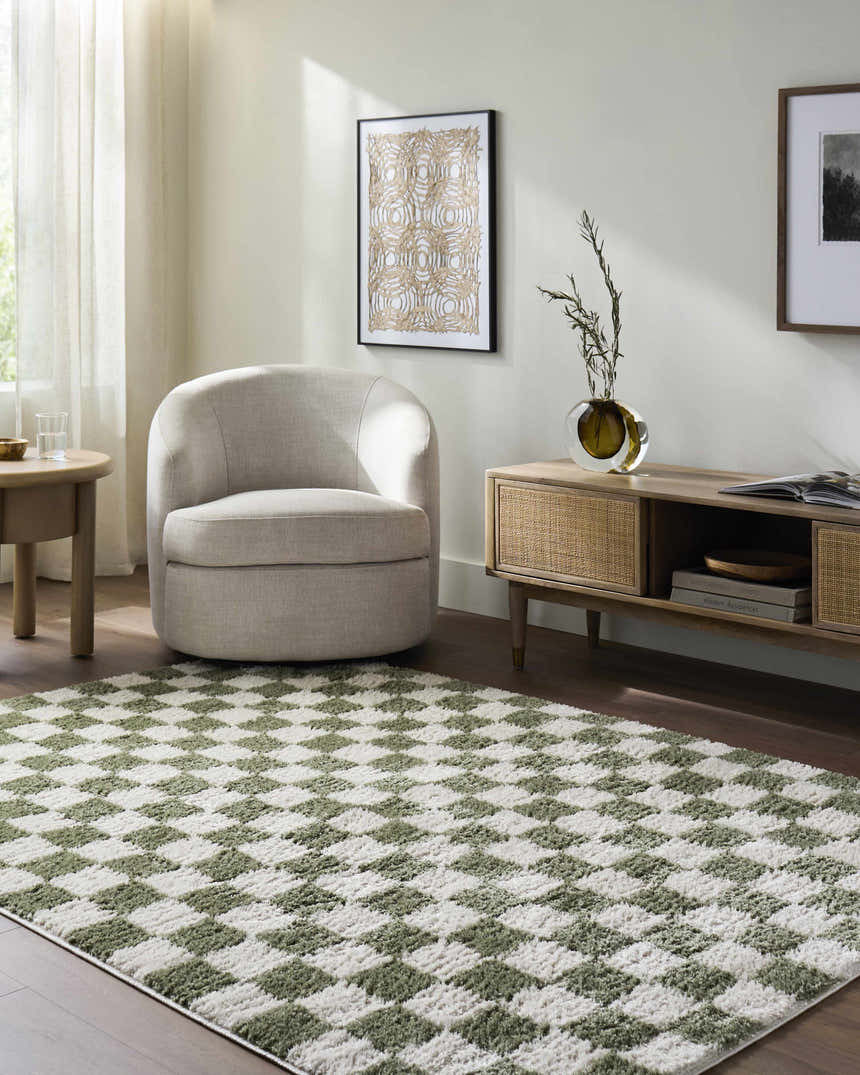 Living room scene with a Canika Green Checkered Washable Plush Rug, neutral chair, wood media console, and light wood floors. Roomscene-Rectangle