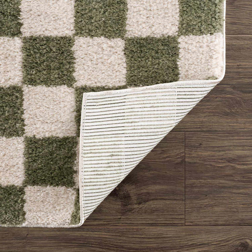 Close-up of the Canika Green Checkered Washable Plush Rug showing the plush texture and non-slip backing. Fold