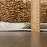 Close-up of the plush texture and pile height of the Canika Green Checkered Washable Rug. Pile