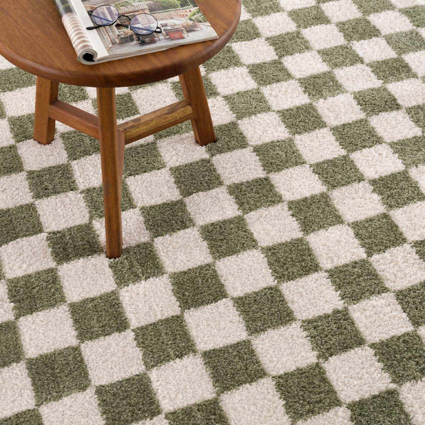 Close-up of Canika Green Checkered Washable Plush Rug. Green and off-white checkerboard pattern with a soft, plush texture. Styleshot