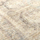 Close-up of the Fetscher V Vintage Damask Area Rug, showing its tan, ivory, and gray textured weave and subtle damask pattern. Texture