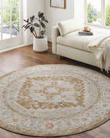 Light-filled room with a round Canadensis Thick Luxe Traditional Turkish Rug, beige daybed, and hardwood floors. Roomscene-Round